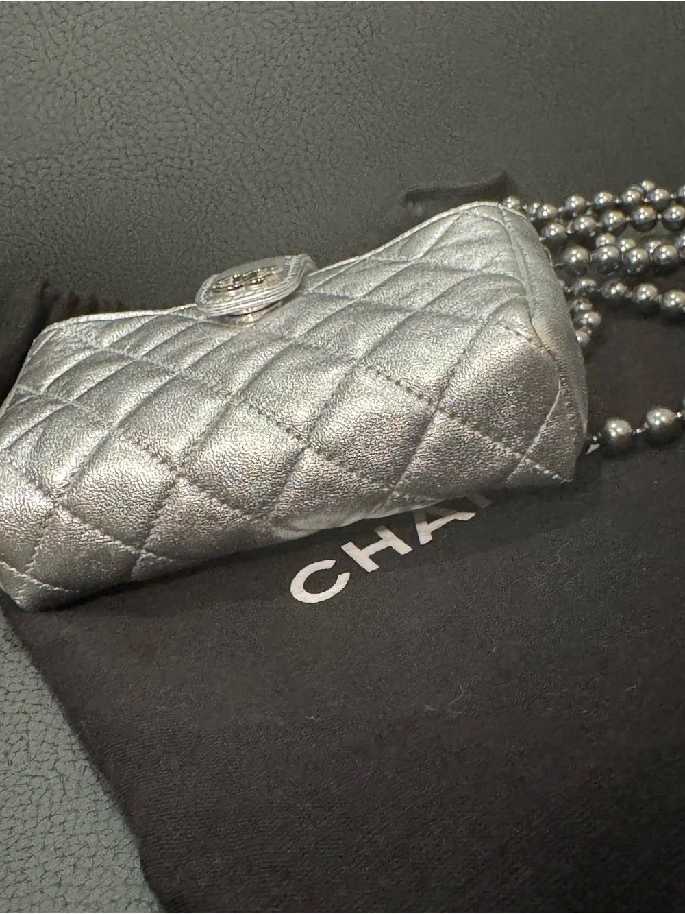 CHANEL Silver Quilted Leather O-Phone Holder with Pearl Chain.